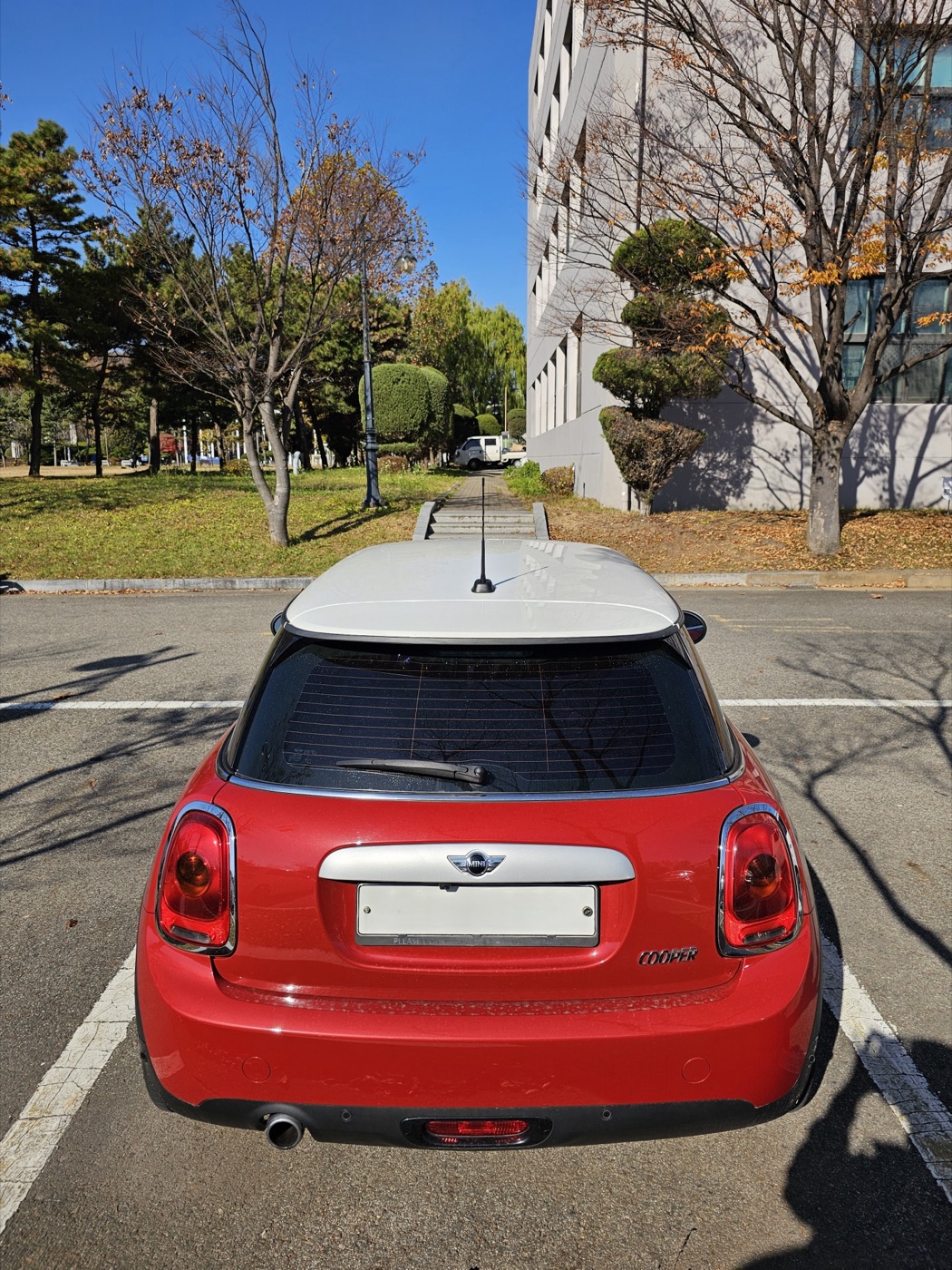 Red Mini Cooper F56 hatchback front three-quarter view